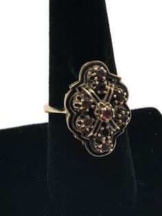 VINTAGE 14K YELLOW GOLD GARNET ART DECO RING This incredible garnet ring is crafted of 14k yellow gold and features 9 round stones. It is finished with detailed gold work. The ring is in nice vintage condition! 9 round .10ct garnets making up the shaped design. 8 Grams Size 8.5 Please message me with any questions I am open to offers : ) Shipped insured/delivery confirmation I guarantee item to be exactly as described and pictured. Black Opal Pendant, Garnet Ring, Gold Work, Deco Ring, Black Gift Boxes, Art Deco Ring, Garnet Rings, Opal Pendants, Black Opal