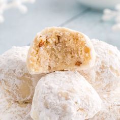 powdered sugar balls stacked on top of each other with a bite taken out of one