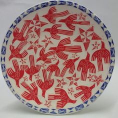 a red, white and blue plate with hands on it