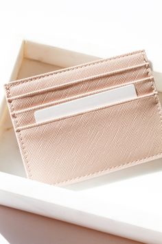 The Saffiano Leather Card Holder Wallet is a sleek, structured and high quality wallet to hold your business cards, school id's and credit cards. The card holder is unisex and is perfect for gifting to a loved one or to treat your self with a new sleek wallet. 3 Front Card Slots Top Opening Slot Faux Leather Sleek Back Flat Surface 4.25x3x0.5 THIS ITEM IS FINAL SALE Trendy Rectangular Card Holder With Card Slots, Trendy Rectangular Card Holder With Slots, Trendy Rectangular Card Holder With Interior Slots, Trendy Bifold Card Holder With Rfid Blocking, Trendy Rfid Blocking Bifold Card Holder, Trendy Bifold Card Holder With Interior Slots, Trendy Rfid-blocking Bifold Card Holder, Modern Card Holder With Id Window As Gift, Trendy Card Holder With Interior Slots For Gift