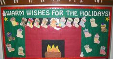 a christmas bulletin board with stockings hanging from the wall and fire place in front of it