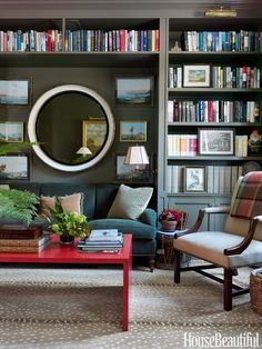 a living room filled with furniture and lots of books