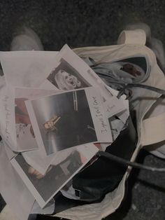 a pile of photos and papers sitting on top of a white shoe