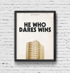 a poster hanging on the side of a white brick wall that says he who dares wins