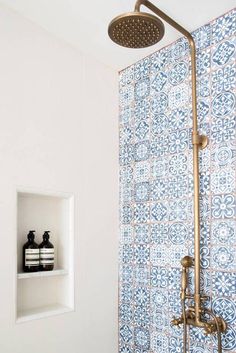 a shower head with thermostaer and hand held faucet in front of it