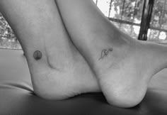 two women's feet with small tattoos on them, one has a shell and the other is a seashell