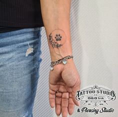 a woman with a tattoo on her wrist holding the hand of another person's arm