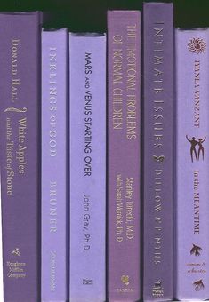 a row of purple books sitting on top of each other