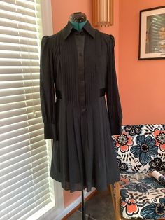 Beautiful Long Sleeve Silk Dress Made by Laundry by Design Tuxedo front buttons  Collared Satin button front strip and waist belt attached Pleated skirt 4" Cuffs Completely lined Knee length  Size 8 Shoulders -15 1/2" Sleeves -25" Bust -38 1/2" Waist -34" Hip - Free Length - 37 1/2" Excellent vintage condition, Beautiful No damages Fitted A-line Shirt Dress With Buttons, Fitted Shirt Dress With Button Cuffs For Work, Fitted Long Sleeve Shirt Dress For Work, Fitted Belted Mini Shirt Dress, Fitted Button-up Belted Shirt Dress, Fitted Belted Button-up Shirt Dress, Fitted Long Sleeve Belted Shirt Dress, Fitted Knee-length Shirt Dress With Pleated Waist, Fitted Button-up Shirt Dress With Pleated Waist