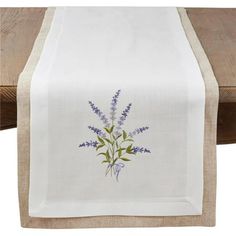 a white table runner with blue flowers on it