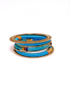 With three skinny silk bangles, two solid and one multi stripe, this theme is driven home by the addition of four golden metal bangles, two of which are powerfully wide and make for beautiful end caps! Each of Laguna's three different color schemes convey a uniquely relaxed, but powerful feeling. www.hamptonbanglecompany.com #bracelets #fashion #jewelry #trend #style #accessory #sexy #bangles  #imaginehappy Metal Bangles, Wrap Bracelet, Different Colors, Leather Bracelet