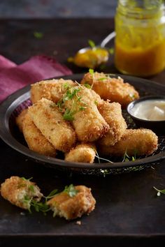 some fried food is on a black plate