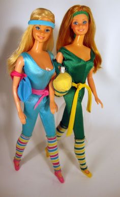 two barbie dolls are standing next to each other on a white background with one holding a ball