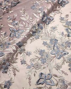 the fabric has blue flowers on it and is very elegantly designed with metallic thread