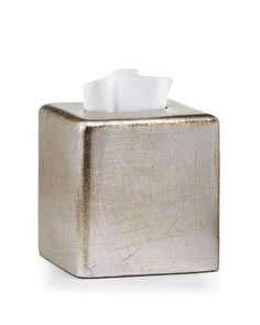 a gold tissue dispenser on a white background