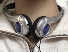 a woman with headphones on her neck