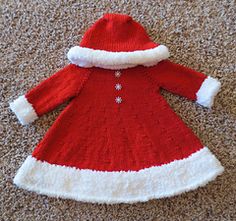 a red and white knitted christmas dress on the floor with snowflakes