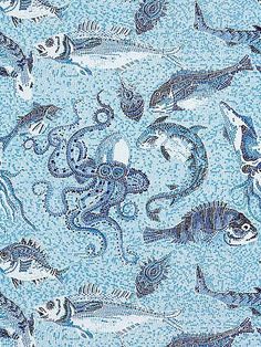 a blue and white tile with fish on it