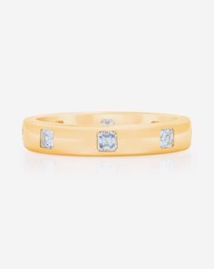 a yellow gold ring with diamonds on it