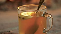 a glass mug filled with liquid and a spoon