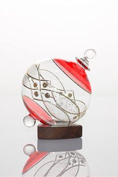 a glass ornament sitting on top of a wooden stand