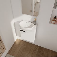 a white sink sitting next to a bathroom mirror on a wall above a wooden floor