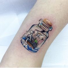 a bottle with a pirate ship in it on the arm