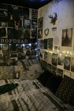 a bed with many pictures on the wall and string lights strung from the headboard