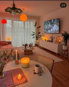 a living room filled with furniture and a flat screen tv mounted to the side of a wall