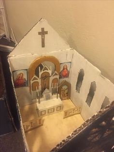 a paper model of a church with pictures on it