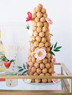 there is a tall cake made out of donuts