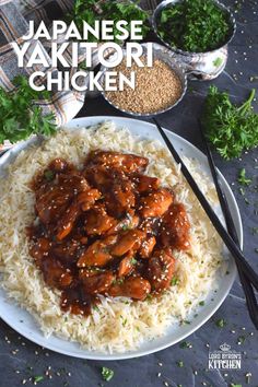 the plate has rice and chicken on it with chopsticks in front of it