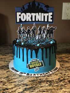 a birthday cake with fortnite figurines on top