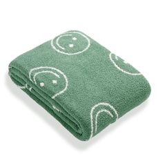 a green towel with white circles on it