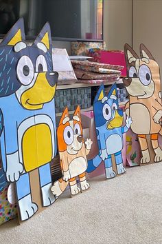 Four large Bluey character boards, setup in a lounge with presents behind. Diy Bluey Centerpieces, Bluey Cardboard Cutout, Diy Bluey Pinata, Diy Bluey Cutouts, Bluey Birthday Centerpieces Diy, Bluey Classroom Decoration, Bluey Classroom Themes