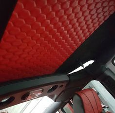 the interior of a vehicle with red seats