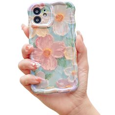 a hand holding an iphone case with pink flowers on the front and bottom, while it is