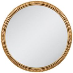 a round gold mirror with beading around the edges and an oval frame, on a white background