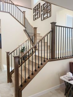 there is a staircase in the house with wrought iron railings and wood balconies