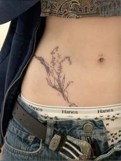 a woman's stomach with tattoos on it