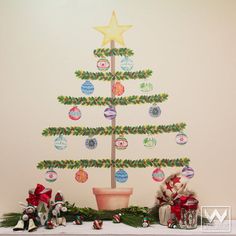 a decorated christmas tree sitting on top of a mantle