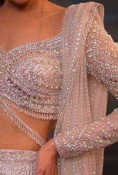 a close up of a woman wearing a silver dress with sequins on it