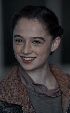 a young woman is smiling for the camera