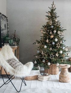 a living room with a christmas tree in the corner and other decorations on the floor