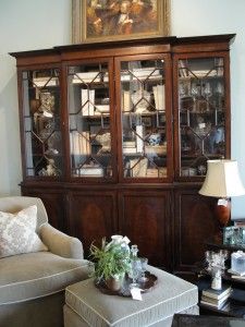 a living room filled with furniture and a painting on the wall