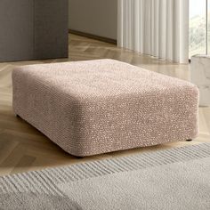 a square footstool sitting on top of a wooden floor next to a window