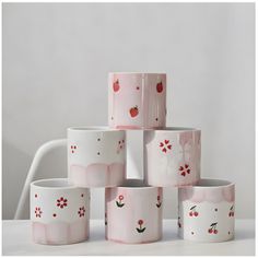 a stack of pink and white cups sitting on top of each other