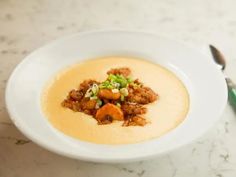 a white bowl filled with soup on top of a table