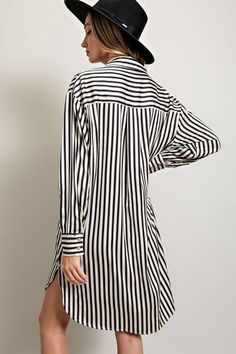 Stripe printed button down shirt dress featuring a collared neckline, one chest pocket, a high-low design, buttoned cuffs, two side slits, and a pleat in the back for added detail. Measurements: Bust: small 46", medium 48", large 50" Front Length: small 35", medium 36", large 37" Back length: small 37", medium 38", large 39" Classic European Style, Button Up Shirt Dress, Shirt Mini Dress, Shirt Pocket, Button Down Shirt Dress, Striped Shirt Dress, Girls Stripes, Striped Mini Dress, Mini Shirt Dress