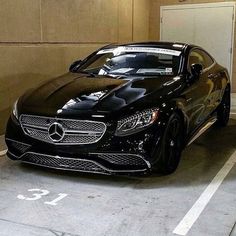 a black car parked in a parking garage